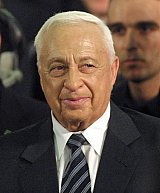 Israeli Prime Minister elect Ariel Sharon smiles during a Likud party rally in Tel Aviv early 07 February 2001. Arch-hawk Sharon stormed to an unprecedented landslide Israeli election win over caretaker Prime Minister Ehud Barak, who announced his resignation as Labour leader and MP after suffering a massive voter backlash over months of bloodletting in the region. AFP PHOTO/Thomas COEX