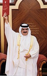 The Emir of Bahrain Sheikh Hamad bin Issa al-Khalifa raises the document proclaiming Bahrain as a kingdom in Manama 14 February 2002. The emir announced that Bahrain will hold elections to restore parliament on October 24, proclaiming the Gulf archipelago a kingdom and himself king. BAHRAIN NEWS AGENCY / AFP